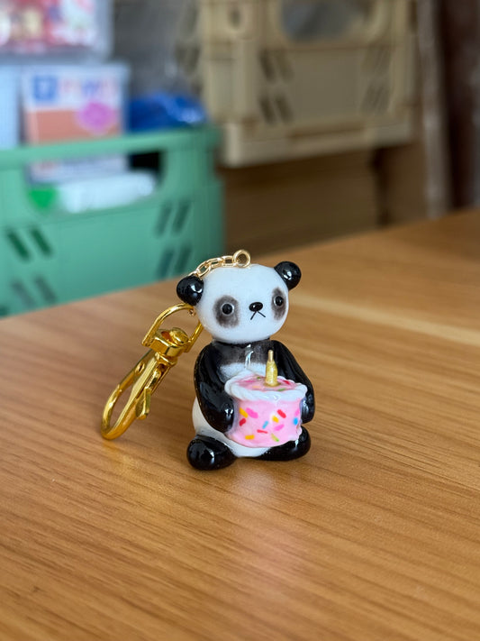 panda holding cake keychain