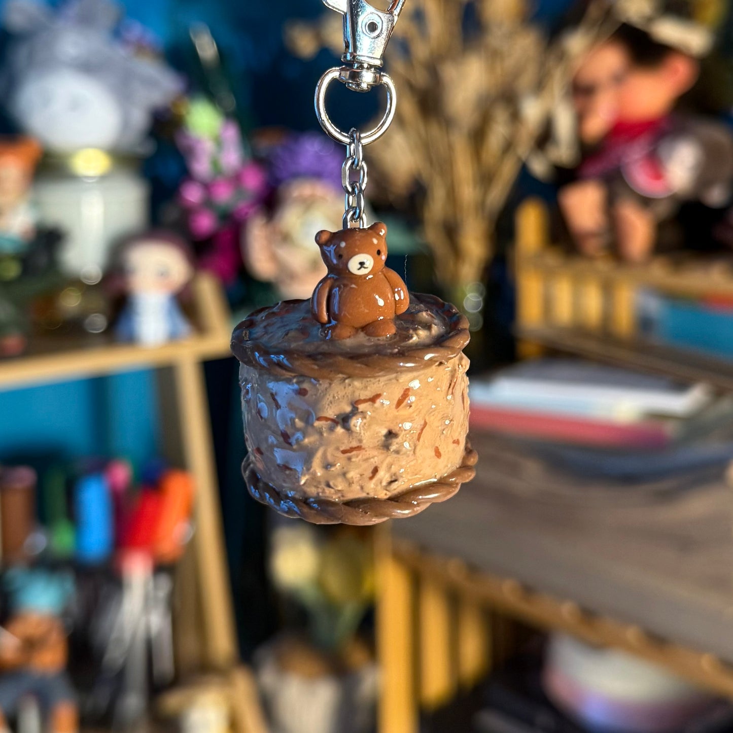 cute keychain with a bear on top of a chocolate cake